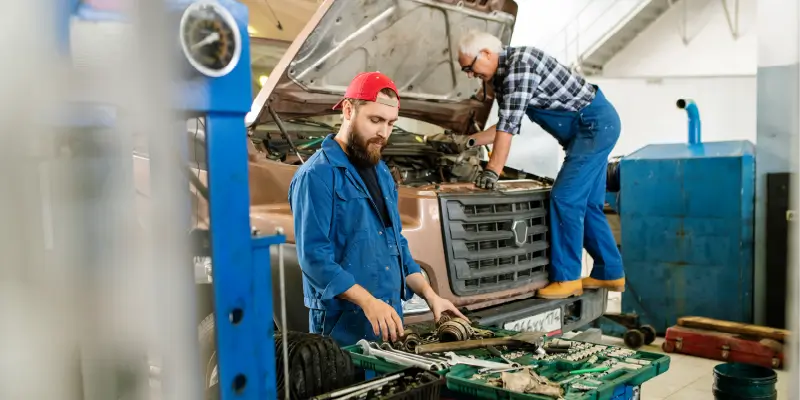 Image of mechanics working on a truck's transmission